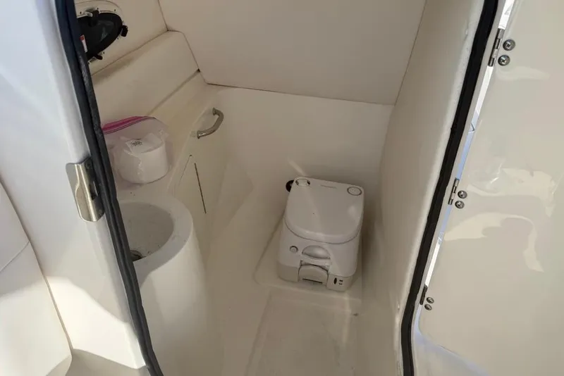 Slide: The Image of Interior of 2012 Sea Ray 260 Sundeck boat bathroom with toilet and sink. - 14