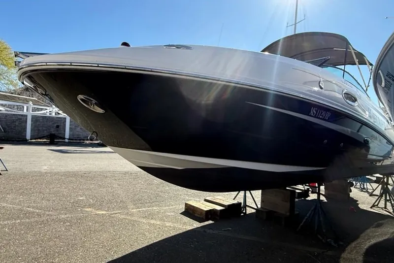 Slide: The Image of 2012 Sea Ray 260 Sundeck boat on dry dock under clear blue sky. - 3