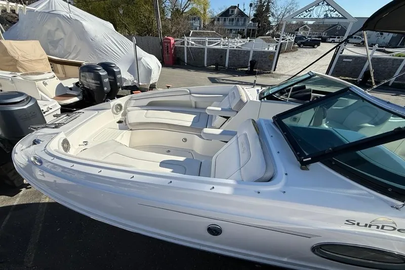 Slide: The Image of 2012 Sea Ray 260 Sundeck boat with spacious seating, docked outdoors. - 8