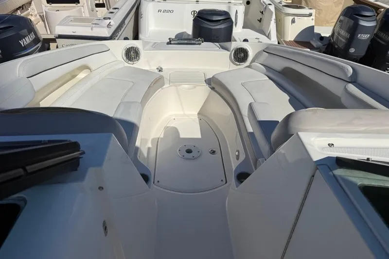 Slide: The Image of 2012 Sea Ray 260 Sundeck interior with white seating and spacious layout. - 9