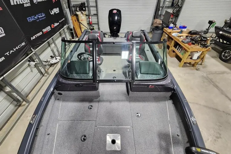 Slide: The Image of 2023 Ranger VS1782SC Reata boat in a garage, showcasing interior and windshield. - 9