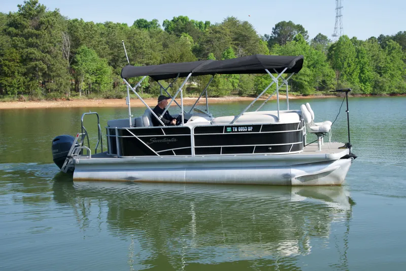 Slide: The Image of 2018 Godfrey Sweetwater20 pontoon boat cruising on a serene lake. - 12