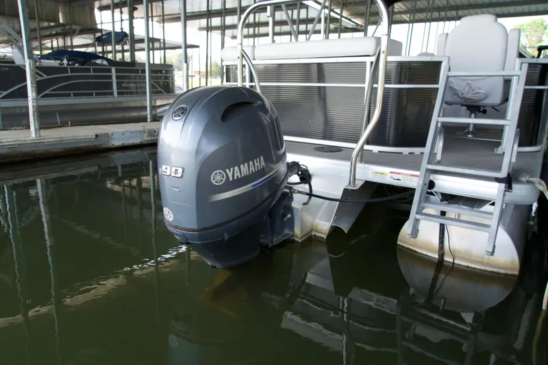 Slide: The Image of 2018 Godfrey Sweetwater20 pontoon boat with Yamaha 90 outboard motor in marina. - 2