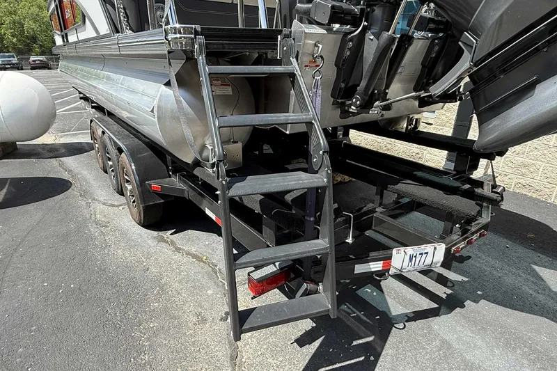 Slide: The Image of Trailer with Barletta LUSSO 25UCAT boat, showcasing rear view and ladder, 2026 model. - 11