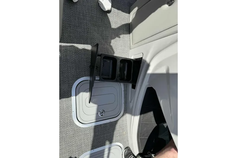 Slide: The Image of 2026 Barletta LUSSO 25UCAT boat interior with cup holder and storage compartment. - 13