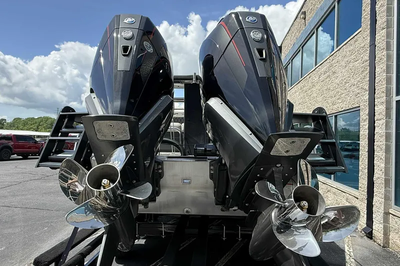 Slide: The Image of 2026 Barletta LUSSO 25UCAT boat with dual outboard motors, parked outdoors. - 42