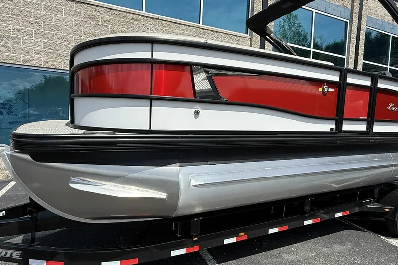 Slide: The Image of 2026 Barletta LUSSO 25UCAT pontoon boat with red and white exterior on a trailer. - 8