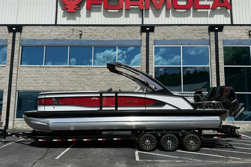 Slide: The Image of 2026 Barletta LUSSO 25UCAT pontoon boat on trailer, parked outside showroom. - 9