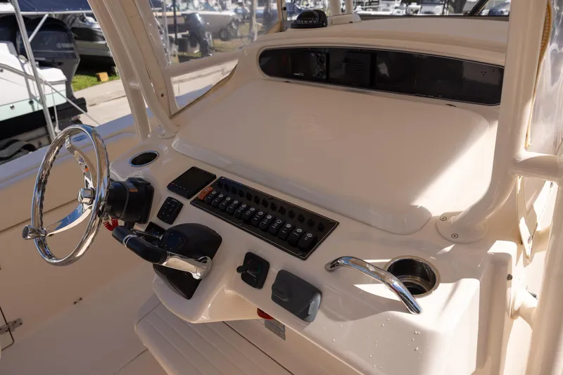 Slide: The Image of 2016 Grady-White Canyon 306 boat helm with steering wheel and control panel. - 11