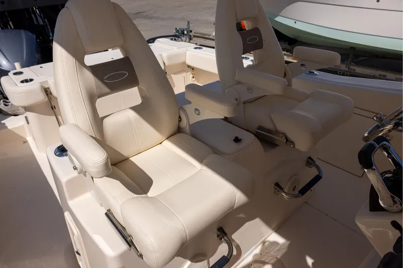 Slide: The Image of Luxurious seating on a 2016 Grady-White Canyon 306 boat, featuring plush white upholstery. - 12