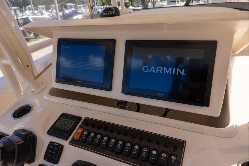 Slide: The Image of 2016 Grady-White Canyon 306 boat dashboard with Garmin navigation displays. - 14