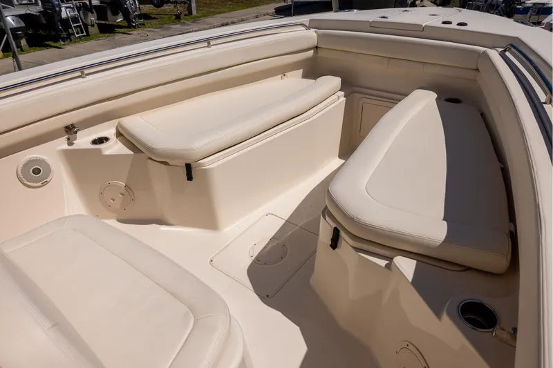 Slide: The Image of 2016 Grady-White Canyon 306 boat interior with cushioned seating and storage compartments. - 16