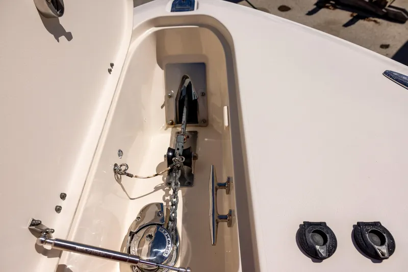 Slide: The Image of Anchor compartment of 2016 Grady-White Canyon 306 boat, featuring chain and cleat. - 17