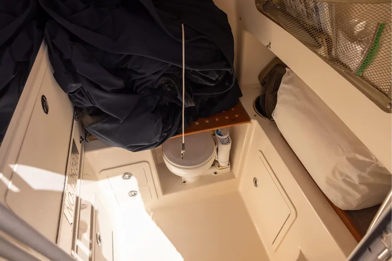 Slide: The Image of Interior of 2016 Grady-White Canyon 306 boat, featuring storage and seating area. - 19