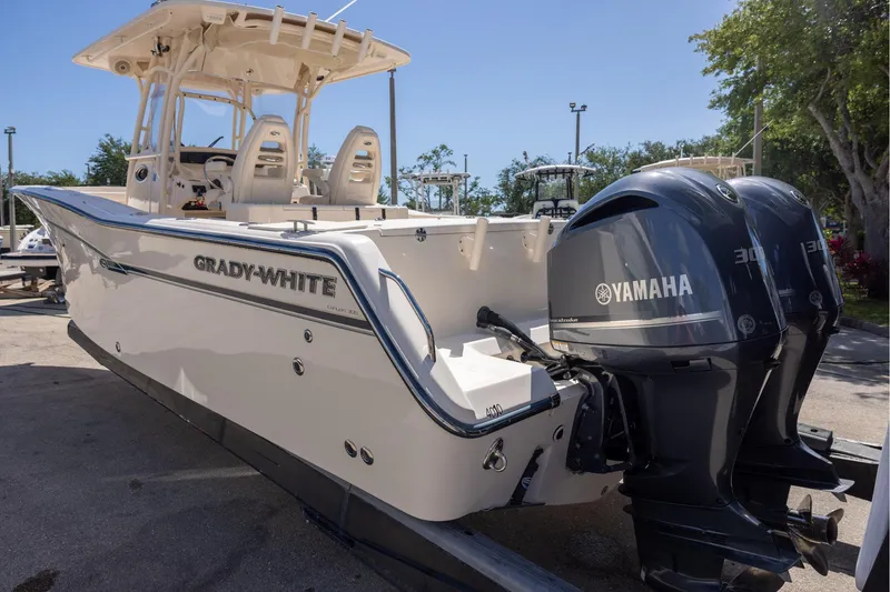 Slide: The Image of 2016 Grady-White Canyon 306 boat with twin Yamaha engines, parked outdoors. - 6