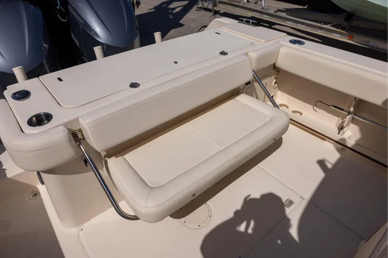 Slide: The Image of 2016 Grady-White Canyon 306 boat interior with foldable seating and cup holders. - 7