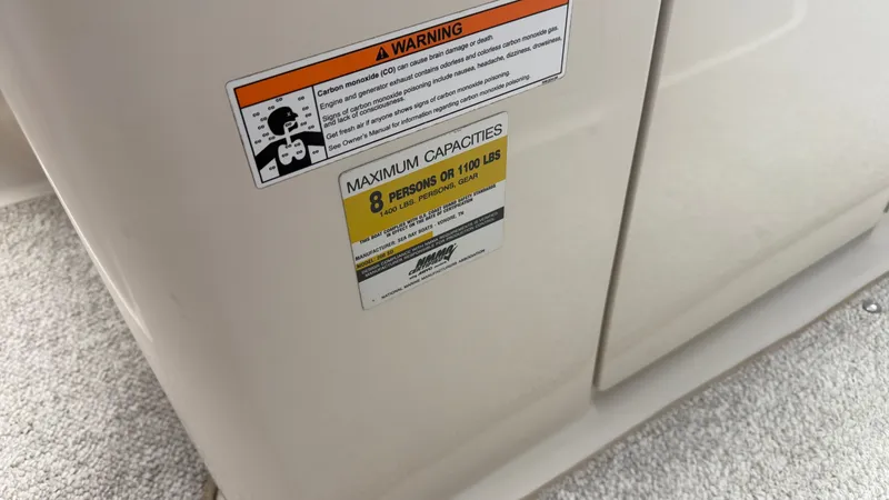 Slide: The Image of Warning labels and capacity sticker on a boat, maximum 8 persons or 1100 pounds. - 46