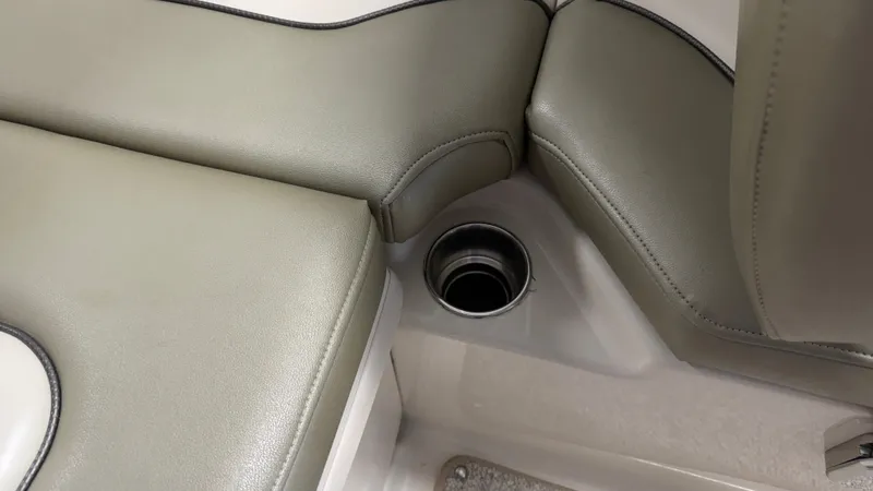 Slide: The Image of Close-up of a seating area with a cup holder on a 2007 Sea Ray 200 Sundeck. - 23