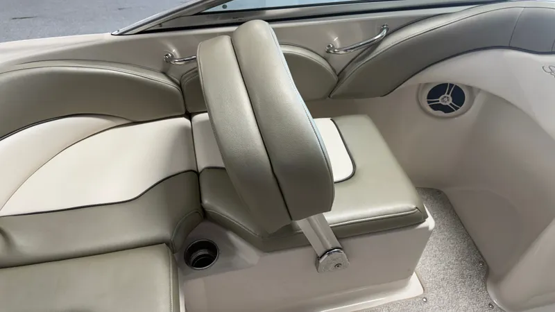 Slide: The Image of The interior of a 2007 Sea Ray 200 Sundeck with beige upholstery and a speaker. - 28