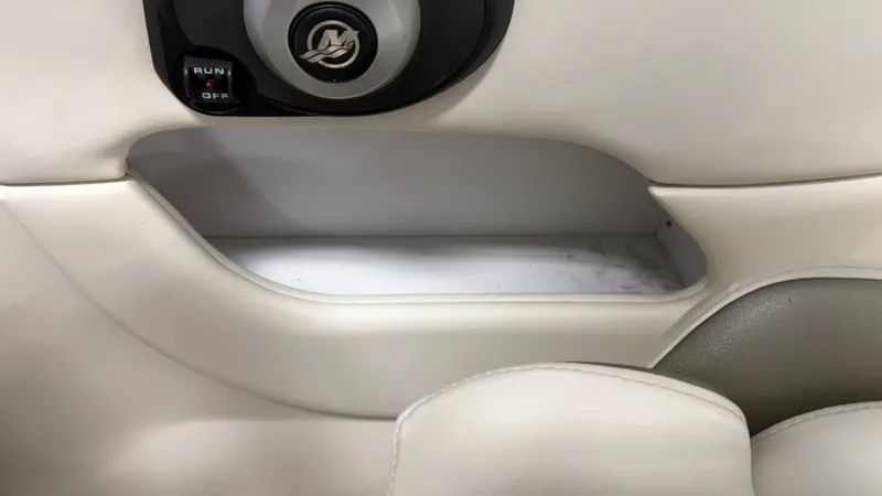Slide: The Image of Close-up of a white boat interior with a small storage compartment and a switch. - 37
