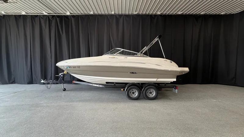 Slide: The Image of A 2007 Sea Ray 200 Sundeck on a trailer in a showroom. - 0
