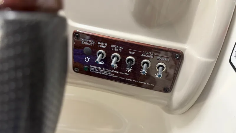 Slide: The Image of Close-up of a control panel with switches for various boat functions. - 39
