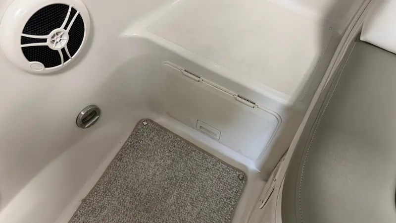 Slide: The Image of Close-up of a white boat interior with speaker, carpet, and seating area. - 18