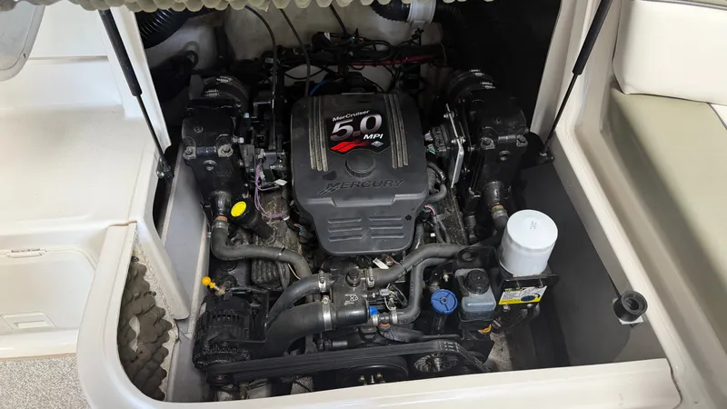 Slide: The Image of The engine compartment of a 2007 Sea Ray 200 Sundeck features a Mercury 5.0 MPI engine. - 21