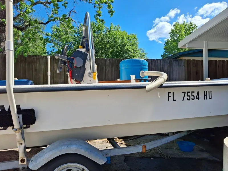 The Image of 1994 Carolina Skiff J boat on trailer, parked outdoors. - 0