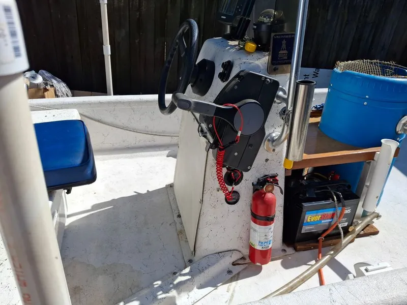Slide: The Image of Interior of a 1994 Carolina Skiff J boat with steering console. - 11