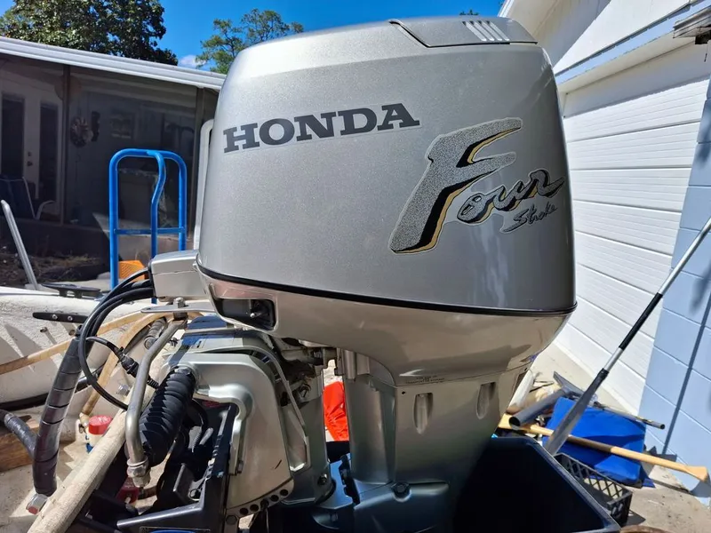 Slide: The Image of Honda four-stroke outboard motor on a 1994 Carolina Skiff J. - 12