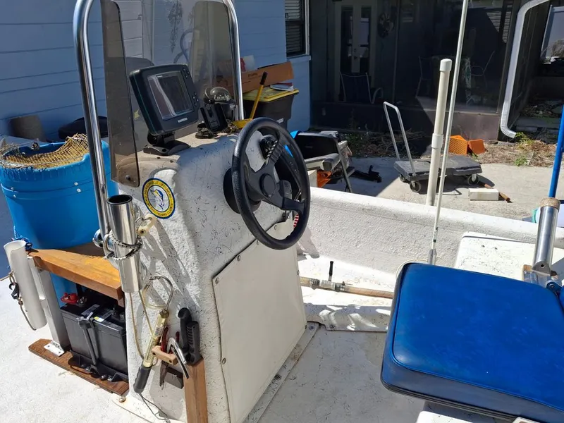 Slide: The Image of Interior of a 1994 Carolina Skiff J boat with steering console. - 2