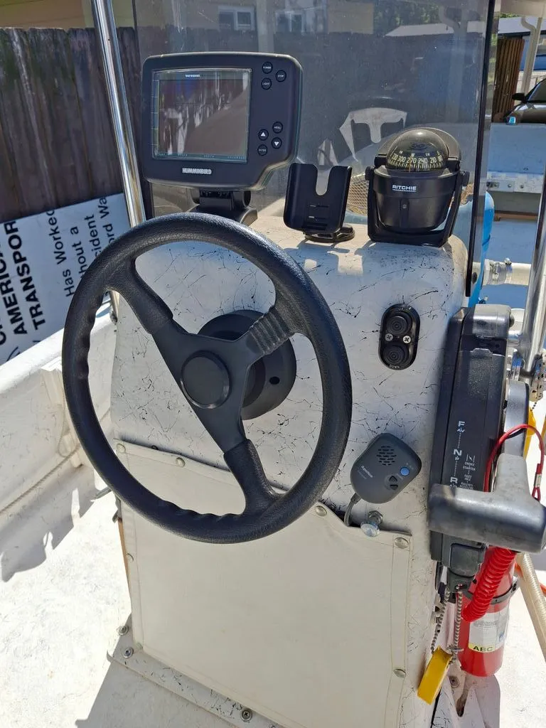 Slide: The Image of 1994 Carolina Skiff J boat helm with compass and electronics. - 3