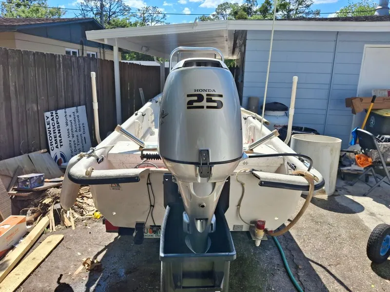 Slide: The Image of 1994 Carolina Skiff J with Honda 25 outboard motor in backyard. - 5
