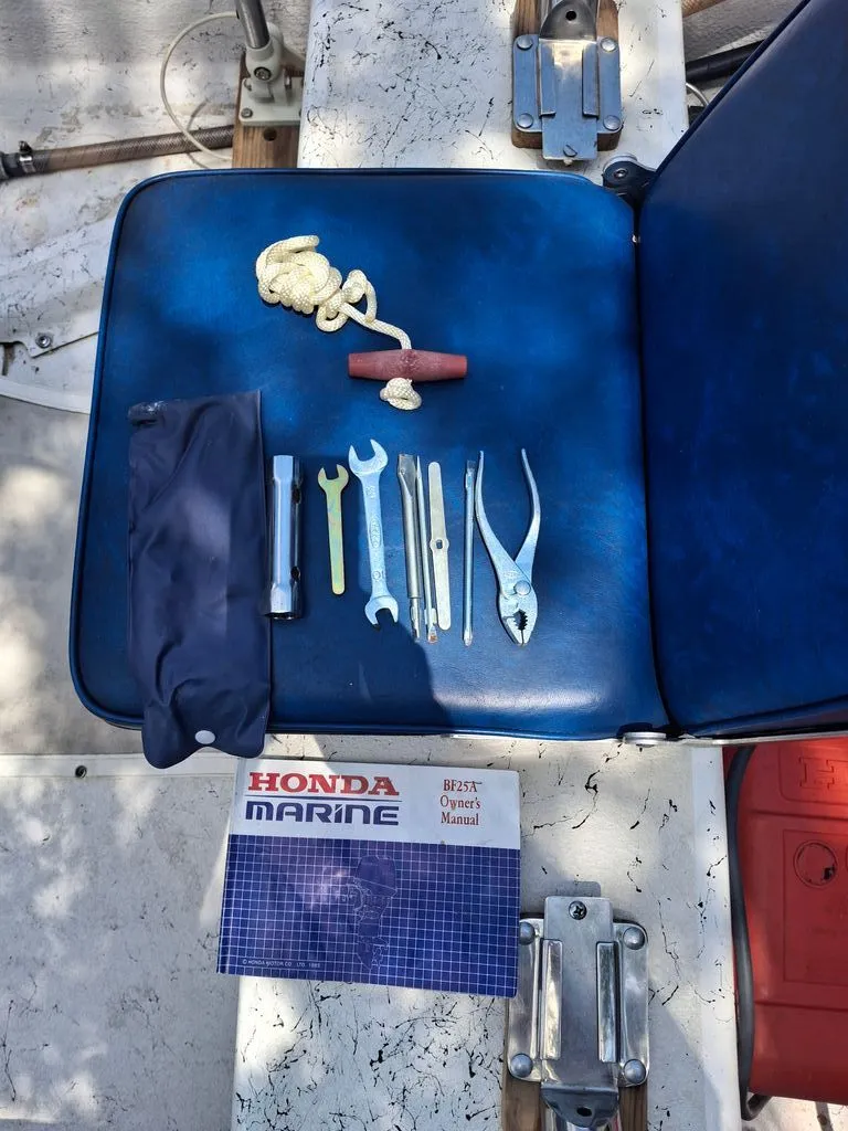 Slide: The Image of Tools and manual on a 1994 Carolina Skiff boat seat. - 6