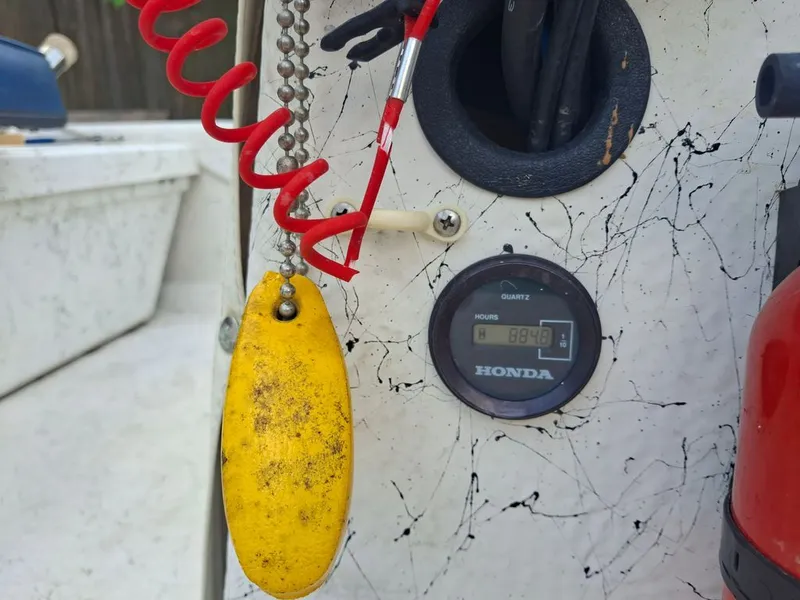 Slide: The Image of Close-up of a 1994 Carolina Skiff J with Honda hour meter. - 7
