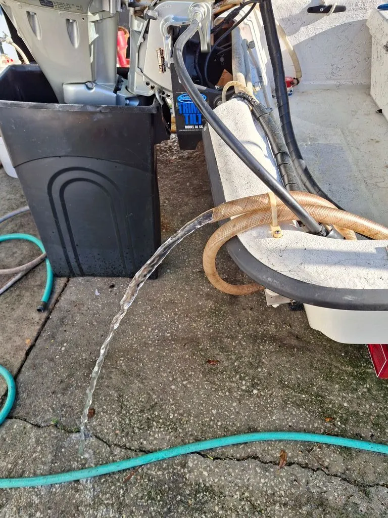 Slide: The Image of 1994 Carolina Skiff J with water hose and motor running. - 8