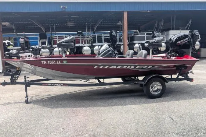 Slide: The Image of 2023 Tracker Pro Team 175 TF fishing boat, red, on trailer, parked outdoors. - 10