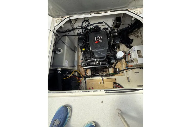Slide: The Image of Engine compartment of a 2005 Larson Cabrio 240 boat, featuring a 5.0 MPI engine. - 13