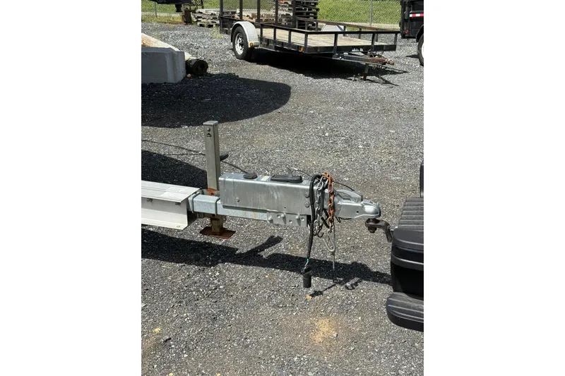 Slide: The Image of Trailer hitch of a 2005 Larson Cabrio 240 boat on gravel surface. - 14