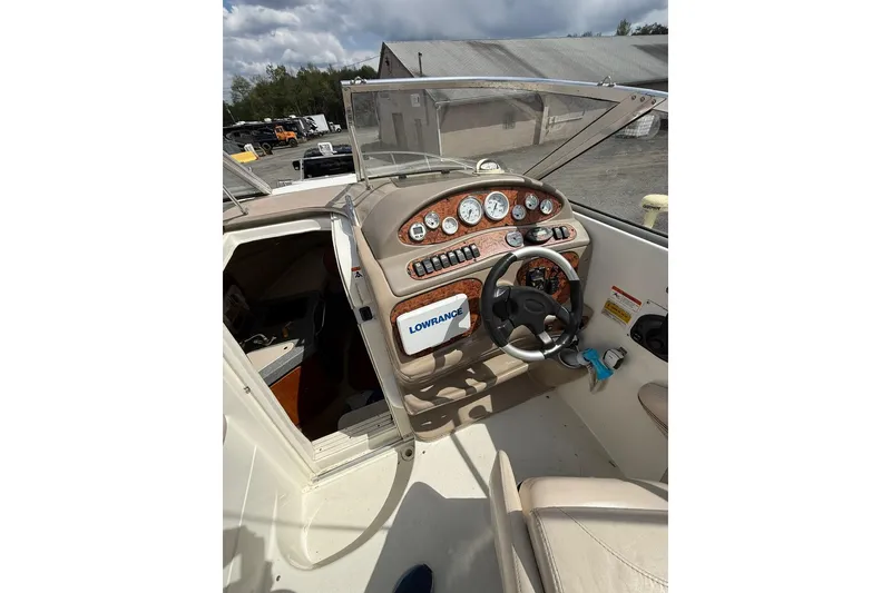 Slide: The Image of 2005 Larson Cabrio 240 boat cockpit with steering wheel and instrument panel. - 6