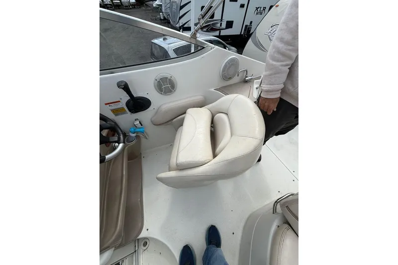 Slide: The Image of 2005 Larson Cabrio 240 boat interior with swivel seat and control panel. - 7