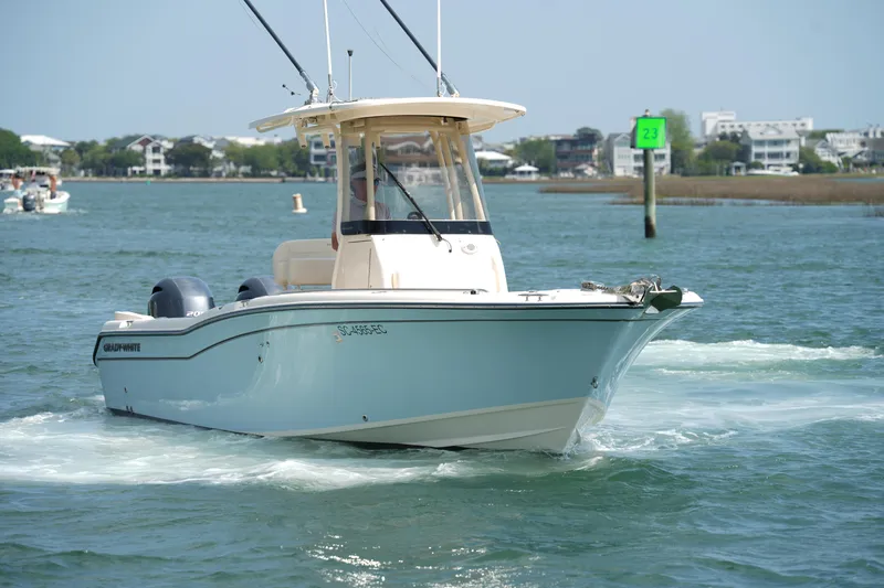 Slide: The Image of 2023 Grady-White Fisherman 257 boat cruising on a sunny day in coastal waters. - 11