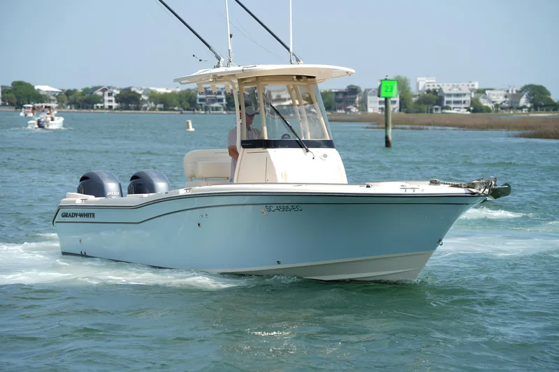 Slide: The Image of 2023 Grady-White Fisherman 257 boat cruising on a sunny day in coastal waters. - 12