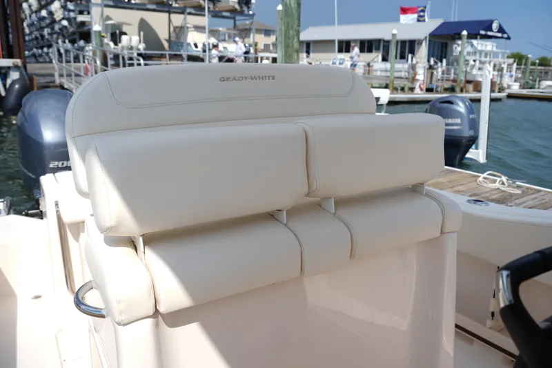 Slide: The Image of 2023 Grady-White Fisherman 257 boat seat, docked with Yamaha engines in background. - 19