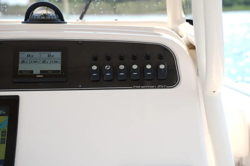 Slide: The Image of 2023 Grady-White Fisherman 257 dashboard with Yamaha controls and navigation instruments. - 23