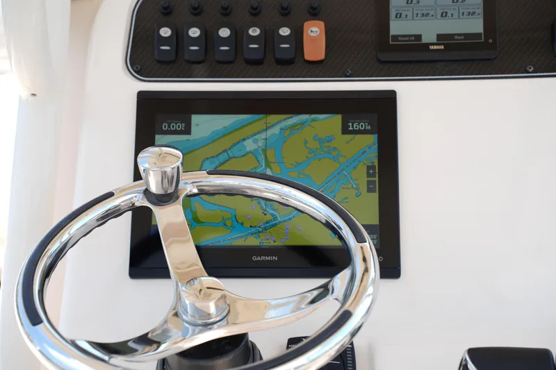 Slide: The Image of Steering wheel and navigation display on 2023 Grady-White Fisherman 257 boat. - 24