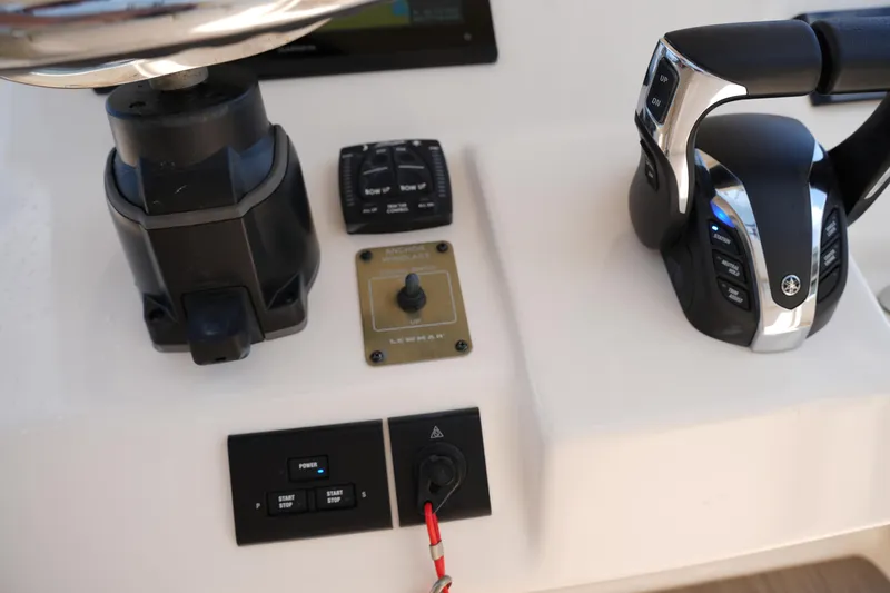 Slide: The Image of Control panel of 2023 Grady-White Fisherman 257 boat, featuring throttle and switches. - 25