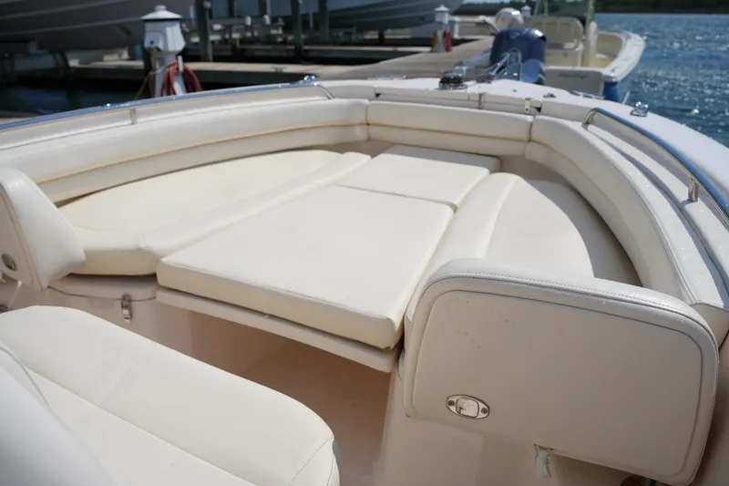 Slide: The Image of 2023 Grady-White Fisherman 257 boat interior with cushioned seating at dock. - 30