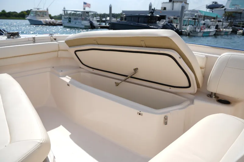 Slide: The Image of 2023 Grady-White Fisherman 257 boat with open storage compartment, docked at marina. - 32